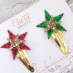 two christmas hair clips with glitter stars on them