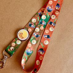 an orange lanyard with buttons on it and a keychain attached to the lanyard