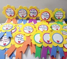 colorful ribbons and badges are displayed on the table for children's birthday party favors