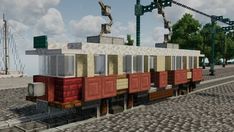 a train car sitting on top of a brick road next to a crane and some trees