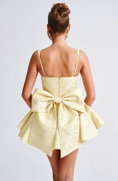 Give us all the pretty playsuits this season! Emelie is made from a premium jacquard fabric with an all-over floral design, cinching at the waist and flaring gently at the skirt which has in-built shorts. With an underwired, balconette bust and lace trim detail, the look is complete with a dramatic oversized bow at the back which you can remove. 



Colour: Lemon.

Floral jacquard fabric.

Fully lined.

Underwired, balconette bust.

Boning in bodice.

Waist cinching.

Adjustable straps.

Lace trim detail.

In-built shorts under skirt.

Removable bow to reverse.

Invisible zipper to reverse.

Mini length.

Model is an XS and is wearing an XS.

 Size: XS, S, M, L, XL, XXL Shorts Under Skirt, Homecoming Dresses Corset, White Dress Spring, Midi Dress Wedding Guest, Dresses Flowy, Split Long Dress, Under Skirt, Maxi Dress Sale, Sparkle Dress