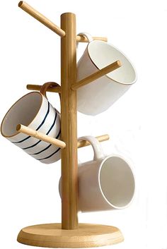 two cups are hanging from a wooden rack