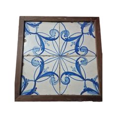 blue and white tile in a wooden frame