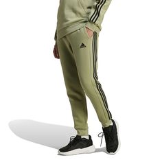 Whether it's a chilly day or you just want extra comfort, these adidas pants are your pick. Made from a soft cotton blend in fluffy fleece, they welcome all-day wear without a second thought. The mid-rise fit is finished with an elastic waist, and the legs taper to ribbed cuffs that let you show off your shoes.Click on this MEN'S GUIDE to find the perfect fit and more! TECHNOLOGIES & FEATURES Fleece 2 side pockets, 1 mobile pocket Ribbed cuffsFIT & SIZING 30-in. inseam Midrise sits above the hip Adidas Hose, Cuff Pants, Cotton Farming, Cuffed Pants, Mens Essentials, Fleece Joggers, Adidas Pants, Bottom Clothes, Adidas Men