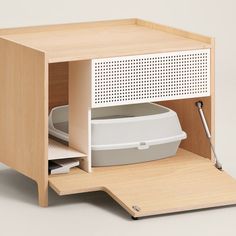 an office desk with a white container in it