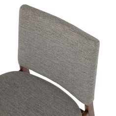 the back of a gray office chair against a white background