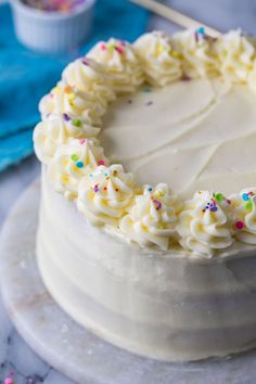 a cake with white frosting and sprinkles