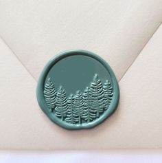 a wax stamp with trees on it