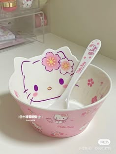 a hello kitty bowl and spoon are on the counter