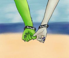 two people holding hands on the beach with their fingers in each other's hand