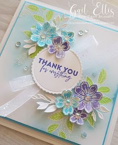 a handmade thank you card with flowers and leaves on the front, in blue and green