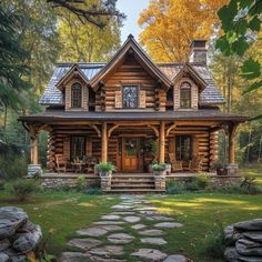 a log home with stone steps leading to the front door