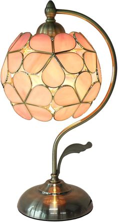 a lamp that is sitting on top of a metal stand with a light bulb in the shape of a ball