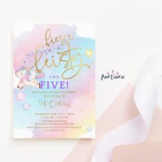 a pink and blue watercolor unicorn birthday party card with gold foil lettering on it