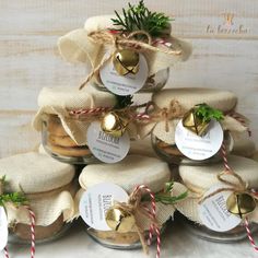 small jars filled with cookies and wrapped in burlocks