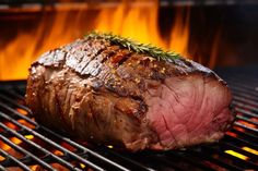 steak on the grill with flames in the background