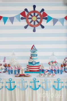 a table topped with a cake next to an anchor