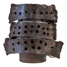 four pieces of metal are stacked on top of each other, with holes in the middle