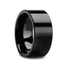 a black wedding band with an inlay design on the center and inside, is shown