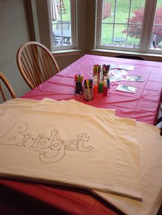 the table is set up for an art class with markers and crayons on it