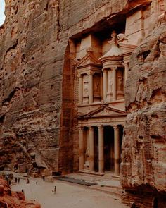 an ancient building carved into the side of a mountain