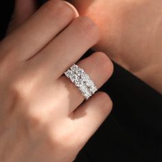 a woman's hand with a diamond ring on it