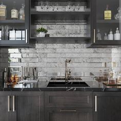 a kitchen with gray cabinets and marble backsplash