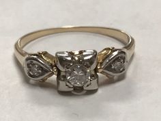 Vintage 14k Gold Diamond Pre-Engagement Promise Ring Size 6.5 A truly superb vintage ring, crafted beautifully in solid 14K gold.  Great worn as a pre-engagement ring or a right hand ring.  In BEAUTIFUL original condition. * Weight: 1.9 grams * Stones: 1 -.20ct round diamond is set into the center mount. There are 2 - .4ct round diamonds on each side of band. * Size & Measurements: The ring is approximately a size 6.5 Will ship in a gift box Victorian 14k Gold Cluster Ring For Anniversary, Vintage Yellow Gold Diamond Ring For Formal Occasions, Antique 14k Gold Diamond Ring With Round Cut, Victorian 14k Stamped Diamond Promise Ring, Antique Wedding Ring With Vvs Clarity, Vintage Wedding Ring With Center Stone For Formal Occasions, Vintage Yellow Gold Ring With Center Stone, Vintage Yellow Gold Rings With Diamond Accents, Antique 14k Stamped Diamond Ring For Anniversary