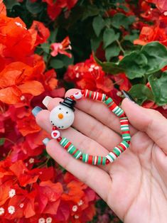 Adorable snowman holiday styled bracelet ❤️ This Christmas themed bracelet is made with red, green, and white 6mm heishi beads, acrylic red heart beads, red seed beads & a ceramic snowman charm  What a better way to spread some cheer? This bracelet is a wonderful accessory for the holidays! ✨ stack it with other jewelry or wear it alone! Gift it to someone special or rock it yourself 💞 (You will receive one snowman bracelet. Not identical to bracelet shown in pic but very similar!) Snowman Accessories, Ceramic Snowman, Heishi Bracelet, Bracelet Christmas, Christmas Bracelet, Christmas Accessories, Crystal Beads Bracelet, Cute Snowman, Holiday Jewelry