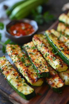 Grilled zucchini with melted cheese and herbs, served on a wooden board with a side of tomato salsa. Zucchini Garlic Bites Air Fryer, Airfry Zucchini Recipes, Zucchini Sticks Air Fryer, Zucchini Bread Sticks, Air Fryer Fried Zucchini, Zucchini Air Fryer Recipes, Zucchini Recipes Air Fryer, Zucchini Fries Air Fryer, Air Fried Zucchini