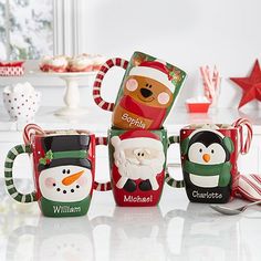 three christmas themed mugs sitting next to each other