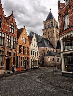 an old european city street lined with brick buildings