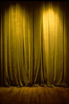 an empty room with curtains and a light on