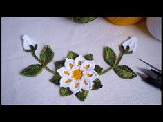 crocheted flowers and leaves on a table