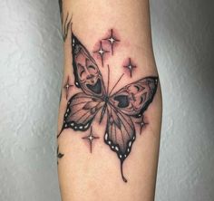 a black and white butterfly tattoo on the right leg, with stars in the background