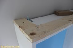 a close up of a wooden counter top in a room with white walls and flooring