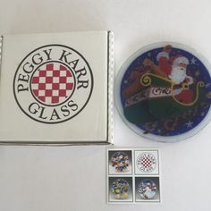 a box with some stickers on it next to a santa clause pin and magnets