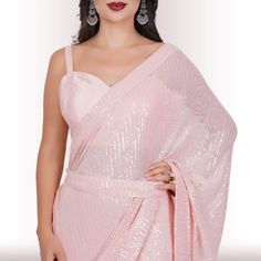 Are you ready to shine? Elevate your style with our Ready-Made Sequin Saree in the enchanting Blush shade. Crafted from high-quality georgette fabric adorned with mesmerizing sequin work, this saree promises a lavish and effortless style upgrade. It effortlessly drapes in less than a minute, ensuring you're ready to dazzle in no time! 🤩😍💃With its exquisite design and easy-to-wear nature, this Ready-Made Sequin Saree makes a statement without the need for elaborate draping or styling. The sequ Festive Pre-draped Saree For Party Season, Elegant Festive Chiffon Blouse, Elegant Pink Blouse With Sheer Dupatta, Elegant Semi-stitched Chiffon Blouse, Feminine Festive Wedding Blouse, Bollywood Chiffon Blouse For Party, Elegant Sequin Fabric For Unstitched Wedding Blouse, Elegant Sequin Fabric For Wedding Blouse, Glamorous Sequin Fabric For Wedding