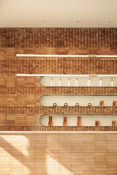 an overhead view of some shelves with coffee cups and spoons on them in a tiled room