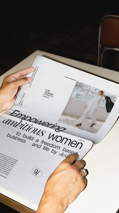 a person is reading a magazine at a table