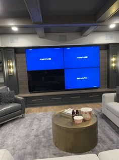 a living room filled with furniture and a flat screen tv mounted on the wall above it