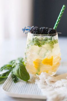 a glass filled with lemonade and blackberries