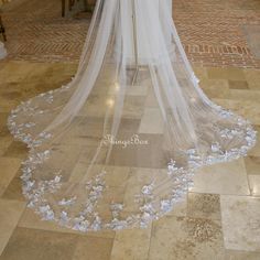 a wedding veil with flowers on the floor