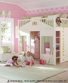 two children playing in a pink and white bedroom