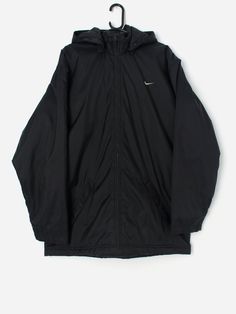 Vintage Nike coat with removable hood. This Y2K Nike coat features a large, thick hood that can be removed (zip). This coat also features a full length zip closure,  two side pockets with zip closures and an inside pocket with a zip closure. The Nike tick is on the front left and is also featured on the back of the jacket. Made from a heavyweight nylon with a nylon lining and a polyester fill.  Our recommended size: Large  Label says: Large  Condition: Good. Tarnishing on the zips. Please see la Solid Hooded Parka With Zipper Closure, Hooded Outerwear With Zip Fly For Winter, Hooded Winter Outerwear With Zip Fly, Nylon Hooded Jacket With Ykk Zipper, Hooded Outerwear With Zip Fly For Streetwear, Casual Winter Parka With Ykk Zipper, Functional Long Sleeve Parka With Zipper Closure, Winter Streetwear Raincoat With Detachable Hood, Urban Winter Windbreaker With Zip Fly