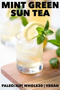 mint green sun tea in a glass on a cutting board