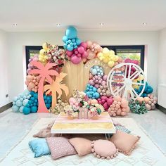 a room decorated with balloons and palm trees