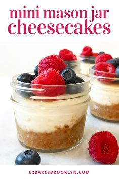 mini mason jar cheesecakes with raspberries and blueberries in the background