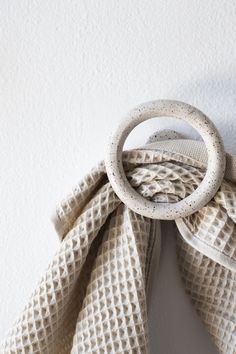 a close up of a cloth hanging on a wall with a circular object in the middle