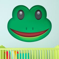 a green frog's face with big eyes and tongue sticking out from behind a crib